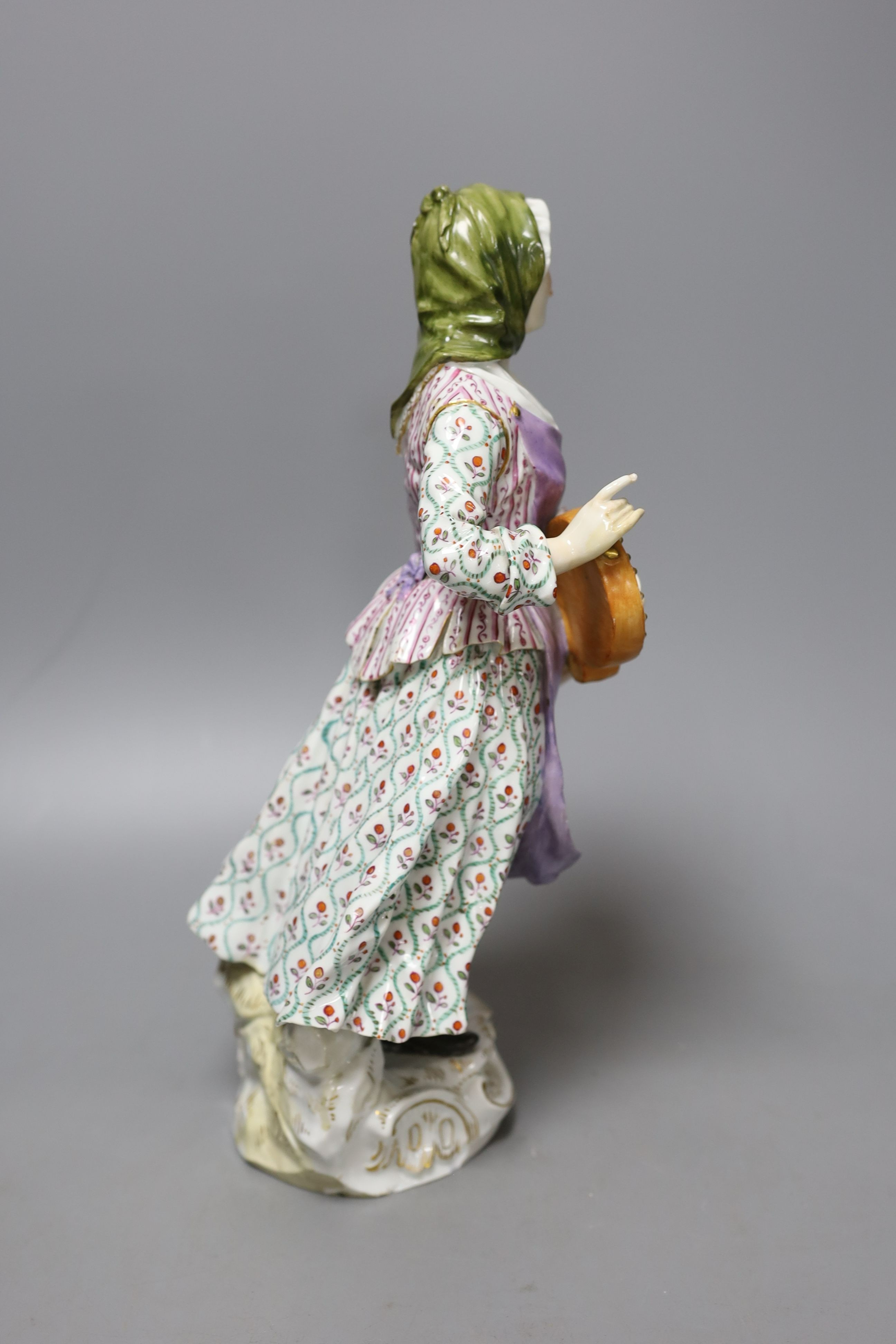 A large Meissen figure of a female hurdy gurdy player, 19th century - 33cm tall